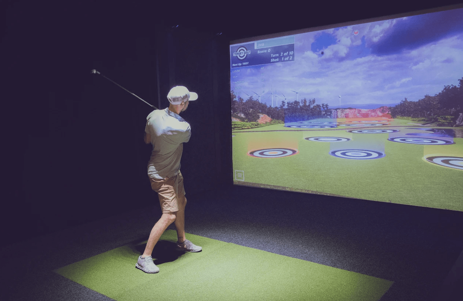 A golfer takes a swing on a Full Swing simulator at Swing Away Golf Club in Birmingham